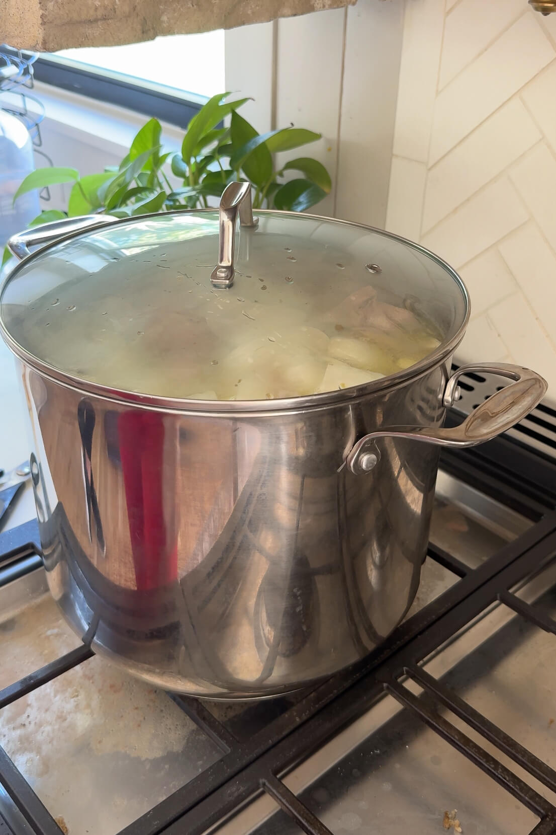 Simmering chicken stock on the stove.